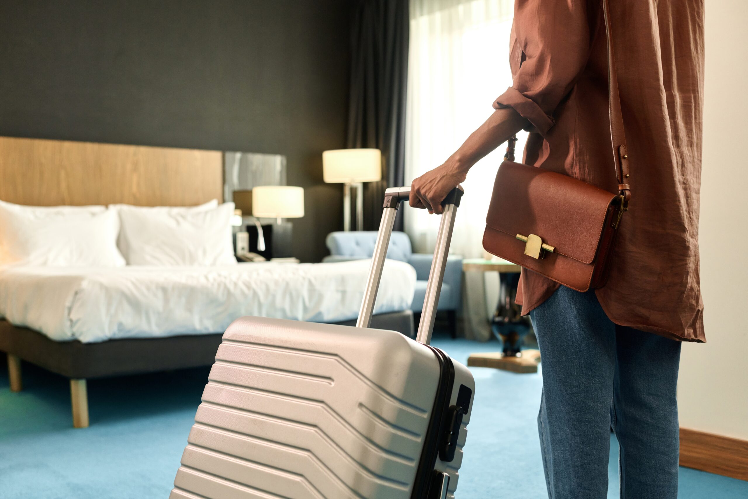 Guest arriving in a hotel room with a suitcase