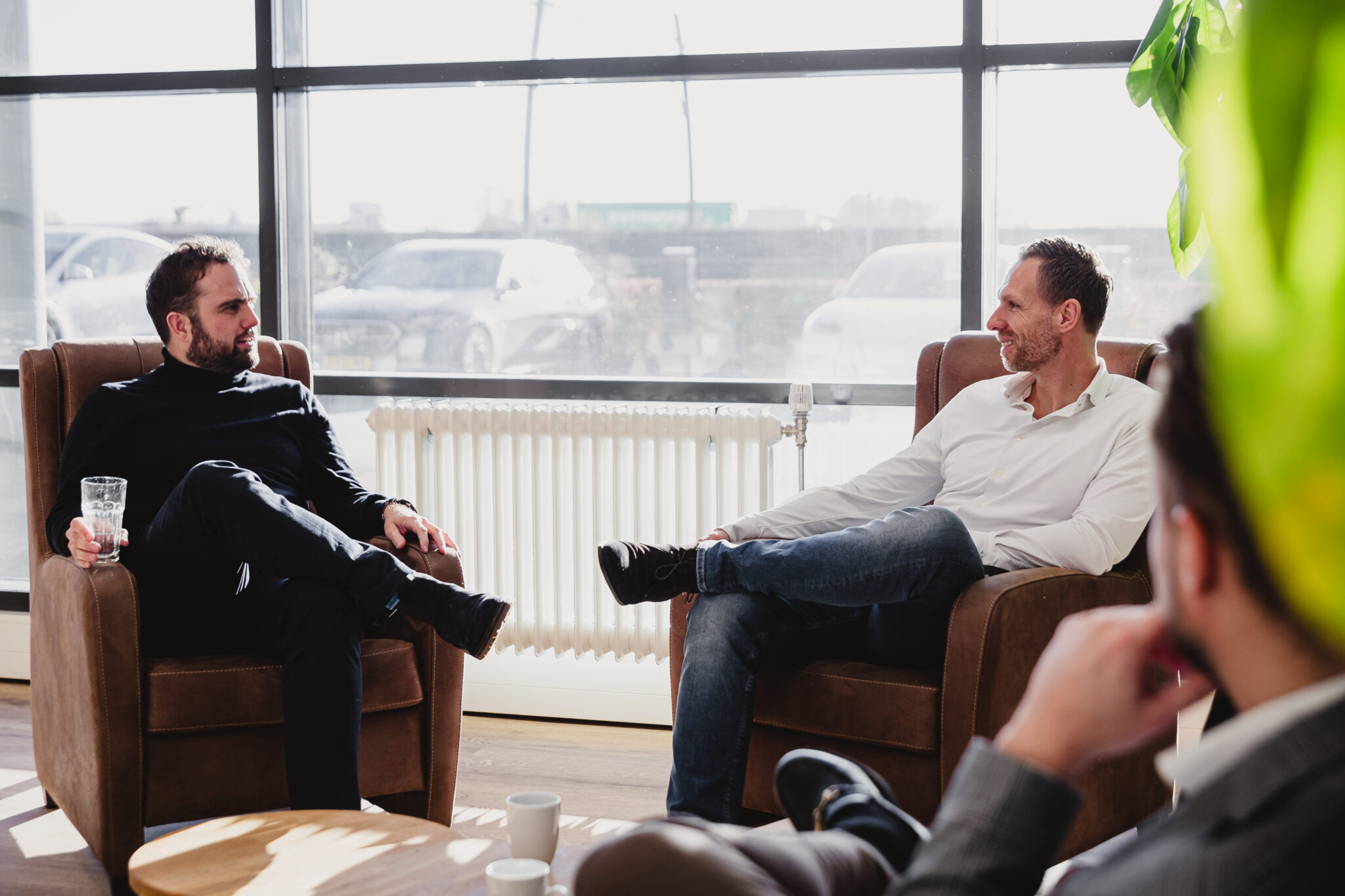 Two people in a chair having a conversation.