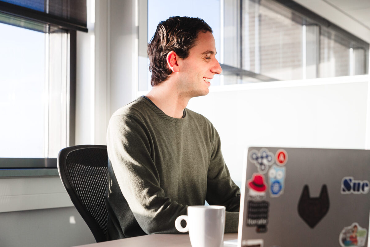 A person behind a laptop, working.