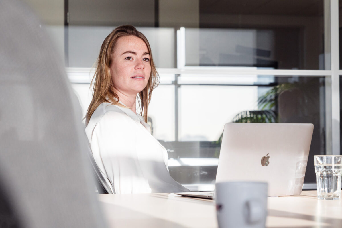 A person behind a desk with a laptop.