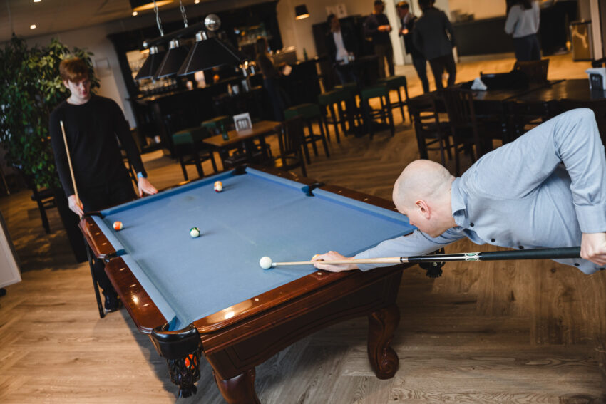 Two people playing pool.
