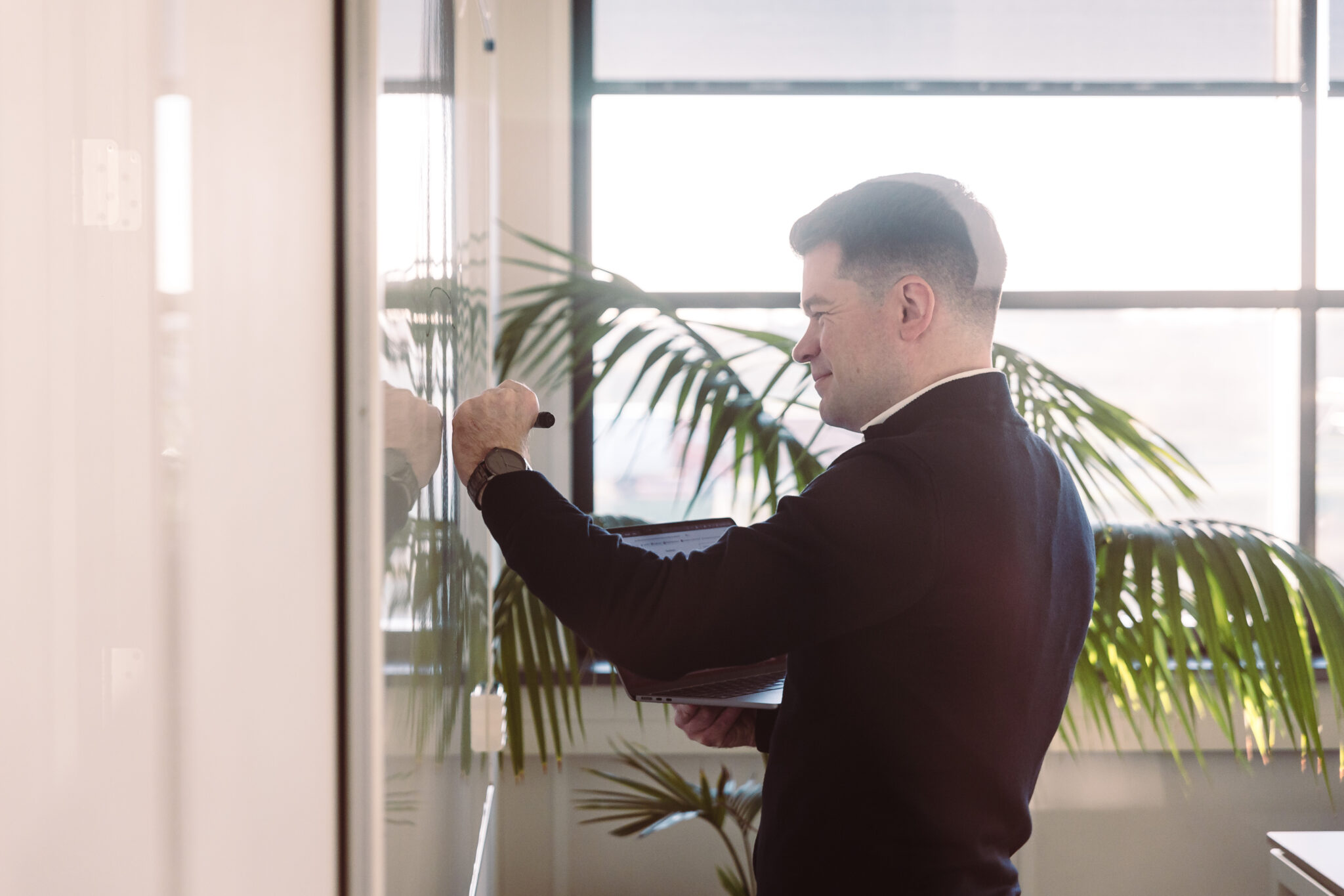 Person in front of a whiteboard writing.